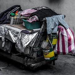 Cart with collected items on the street. Photo by Gio Almonte on Unsplash