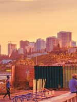 Photo of sunset in Maputo, Mozambique. Photo includes a beach and high-rise buildings in the background.