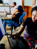 two people sitting in front of a computer